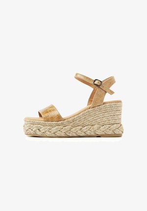 Tan wedge sandal with braided jute platform, open toe, and ankle strap with metal buckle on white background.