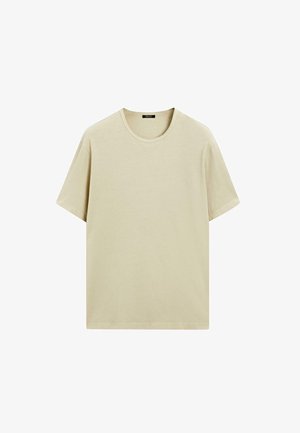 Beige cotton T-shirt with short sleeves and a round neckline. The fabric has a smooth texture and a relaxed fit. No graphics or patterns.