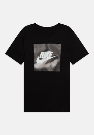 Black cotton t-shirt with a crew neck, featuring a silver reflective Nike logo within a square graphic on the front.