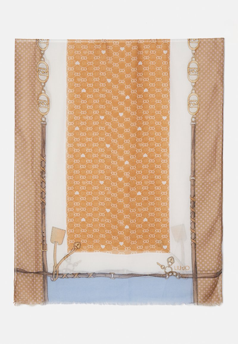 Silk scarf features a warm orange patterned center, bordered by polka dots and intricate chain designs, with frayed edges for texture.