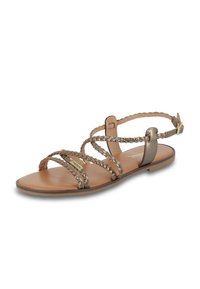 Sandalias planas con tiras metálicas trenzadas en un tono bronce claro, plantilla de cuero y una correa ajustable en el tobillo. Textura suave.