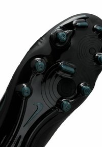 Black football boot sole with circular patterns and six conical studs. Features a textured surface and a prominent curved design.
