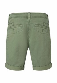 Green cotton shorts with rolled cuffs, featuring two back pockets with horizontal zippers and subtle stitching details.