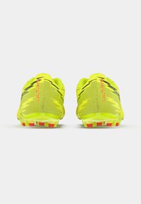 Yellow soccer cleats with a mesh upper, black accents, and red detailing. Features a low profile and sturdy grip studs for traction.