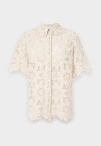 Blusa in pizzo crema, caratterizzata da motivi floreali all'uncinetto, colletto, maniche corte e dettagli a forma di scallop all'orlo. Chiusura con bottoni frontale.