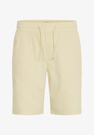 Shorts beige clair en tissu doux, avec une taille élastique, un cordon de serrage et des poches latérales. Design simple, coupe légèrement ample.