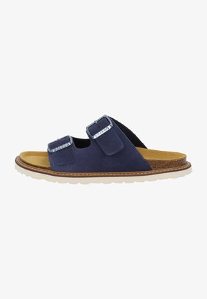 Navy blue suede slide sandal with two adjustable straps, metal buckles, tan footbed, and white textured sole.