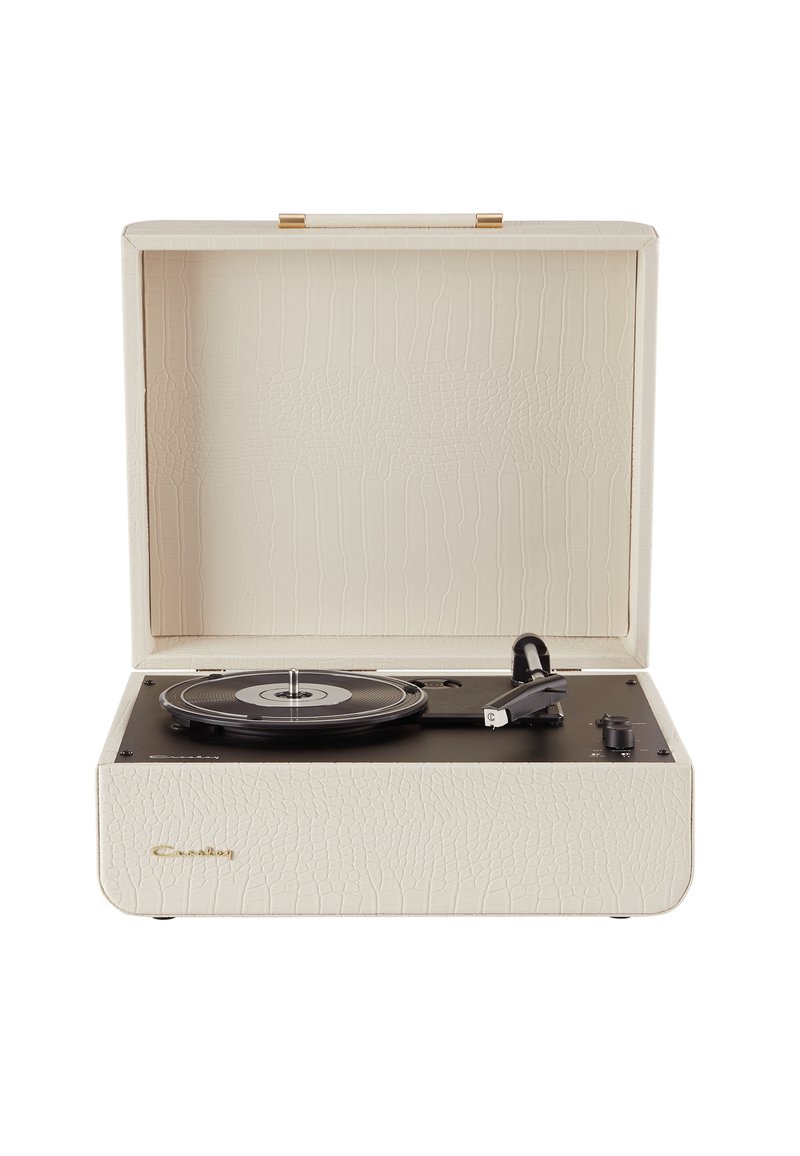 Portable record player with a textured cream exterior, black turntable, and gold hardware accents. Features control knobs on the side.
