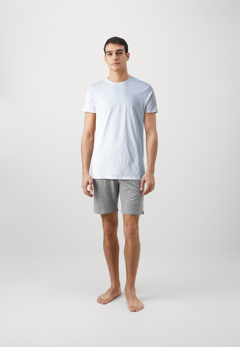Light blue short-sleeve t-shirt paired with gray shorts. Both garments have a casual fit and are made from soft materials.
