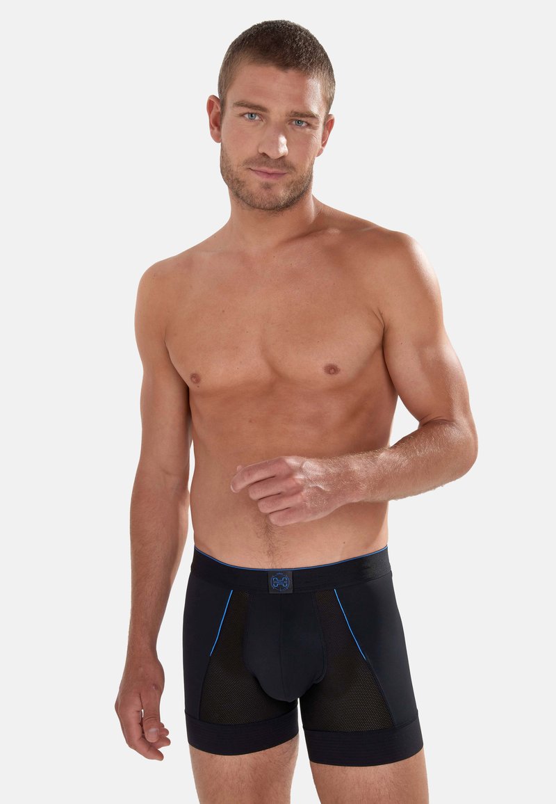 Schwarze Boxer-Brief mit blauen Akzenten, Netzpaneelen und elastischem Bund. Das Material bietet Dehnbarkeit und eine enge Passform.