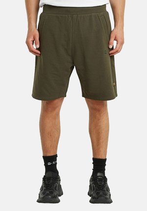 Olivengrønne træningsshorts med elastisk talje, sidelommer og diskret branding. Fremstillet af blødt bomuldsblandingsstof.