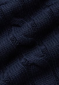 Granatowa dzianina z fakturalnym wzorem i widocznymi ściegami, prezentująca miękki, ciepły i elastyczny materiał.