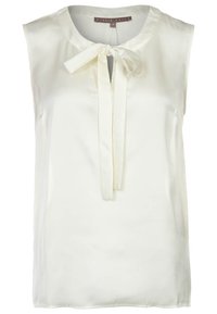 Bezrukává krémová blůza z hladkého materiálu, s kulatým výstřihem a mašlí vpředu. Bez viditelných vzorů nebo akcentů.