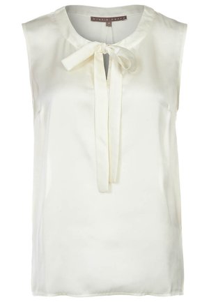 Ærmeløs cremefarvet bluse lavet af glat stof, med rund halsudskæring og en sløjfedetail foran. Ingen synlige mønstre eller accenter.