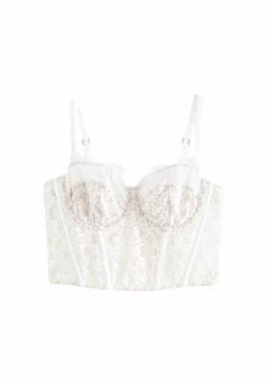White lace bra with floral pattern, molded cups, adjustable straps, and vertical seams. Smooth texture with delicate detailing.