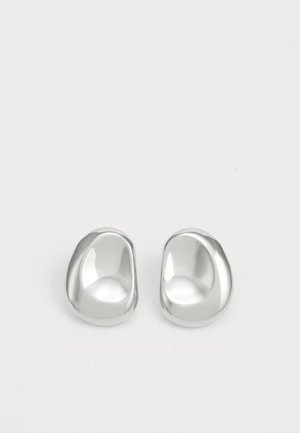 Silver ear studs with a smooth, rounded design, featuring a reflective surface and gentle curves, giving an organic, pebble-like appearance.