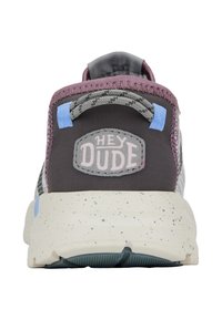 Sneaker in tessuto grigio con accenti viola, targhetta rotonda sul tallone, logo "HEY DUDE" e suola bianca maculata. Presenta una texture liscia e cuciture rinforzate.