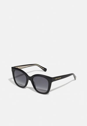 Black oversized square sunglasses with gradient dark lenses and "Tommy Hilfiger" gold logo on the temple arms.