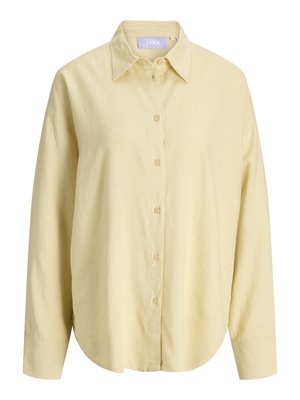 Chemise à manches longues, jaune pâle, boutonnée, avec un col classique et un ourlet arrondi, fabriquée dans un tissu léger.