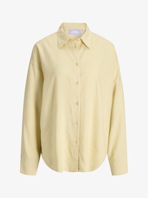 Chemise à manches longues, jaune pâle, boutonnée, avec un col classique et un ourlet arrondi, fabriquée dans un tissu léger.