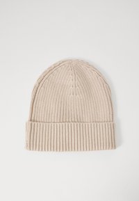 Knit beige beanie with a ribbed cuff and textured crown, featuring vertical and horizontal stitching patterns throughout.