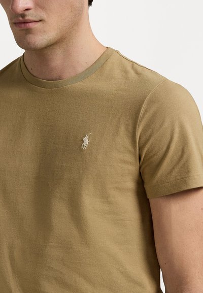 Short-sleeve, crew-neck t-shirt in khaki cotton with a textured finish. Features a small, embroidered logo on the left chest.