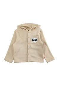 Chemise à capuche beige en tissu doux, dotée d'une fermeture à boutons, d'une texture côtelée et d'une poche plaquée avec un détail de texte noir.