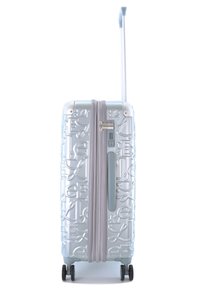 Valise rigide avec une finition brillante bleu clair, motif de lettres en relief, poignée rétractable, fermeture éclair et quatre roues noires.