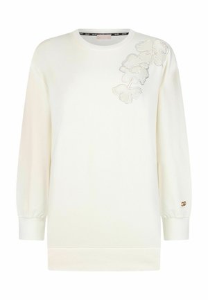 Sweat-shirt crème à manches longues avec broderie florale sur l'épaule et petit logo en métal sur le poignet.