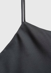 Zwarte satijnen camisole met dunne bandjes, een zachte textuur en een gedrapeerd ontwerp met een subtiele glans.