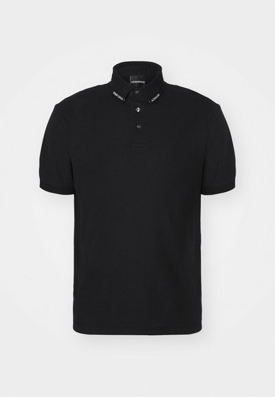 Black polo shirt made from cotton, featuring a structured collar, three-button placket, and embroidered branding on the collar.