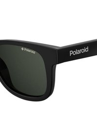 Occhiali da sole neri con lenti scure, forma rettangolare, con una finitura opaca, design semplice e un logo sulla tempia.