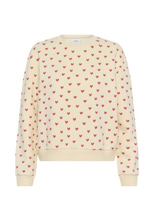 Krem duks s uzorkom malih crvenih srca, sa rebrastim manžetama i rubom, izrađen od mekanog tkanja s opuštenim krojem.