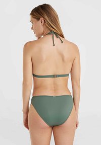 Green bikini set featuring a halter neck top with a tie closure and high-waisted bottom. Smooth fabric with a minimalistic design.