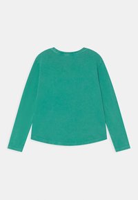 Camisa de manga longa em teal sólido, feita de algodão suave. Apresenta um decote redondo e um corte relaxado com barra reta e punhos cosidos.