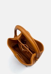 Brown leather handbag with a structured shape, featuring a top handle, interior pockets, and a secure snap closure. Smooth texture.