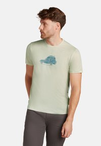 Hellgrünes T-Shirt mit kurzen Ärmeln aus einem glatten Stoff, mit einem blauen Grafikdruck eines Vans auf der Vorderseite. Rundhalsausschnitt und reguläre Passform.
