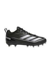Scarpa da calcio nera con tomaia sintetica, superficie texturizzata, design a tre strisce bianche e tacchetti trasparenti per la trazione sull'erba.