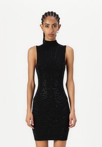 Rochie neagră fără mâneci, cu guler înalt, brodată cu modele intricate din mărgele, cu o siluetă ajustată și o țesătură texturată.