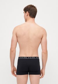 Black boxer briefs made of stretch fabric with a branded elastic waistband displaying "PIER ONE" in white lettering.