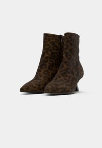 Botines de ante suave con estampado de leopardo. Con punta afilada, tacón bajo y cremallera lateral para facilitar su uso.