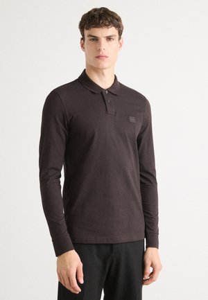 Long-sleeve dark brown polo shirt made of cotton, featuring a three-button placket and a small logo patch on the chest.