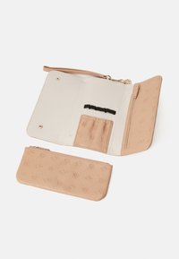 Beige leather purse with embossed floral pattern, featuring a zippered exterior pocket, interior card slots, and removable wrist strap.