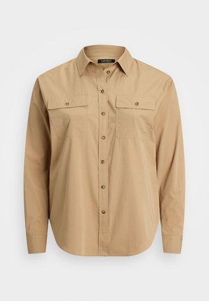Chemise beige à boutons, en tissu léger, dotée d'un col, de deux poches poitrine et d'un ourlet droit.