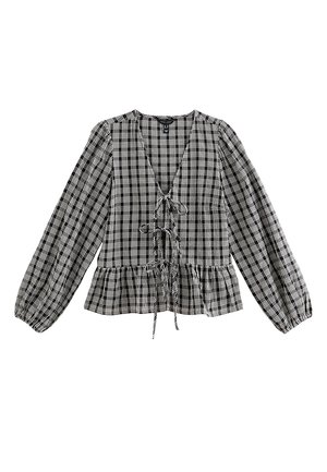 Blouse à basque à carreaux noir et blanc avec un col en V, un devant à cordon et de longues manches bouffantes. Fabriquée en tissu léger.