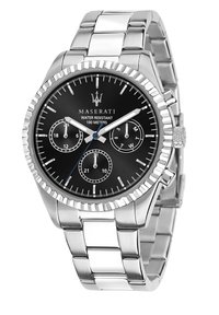 Sölvfärgad rostfritt stål klocka med svart urtavla, tre strävanledare och en roterande strukturerad bezel. Vattenbeständig upp till 100 meter.