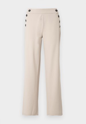 Pantalon beige sur mesure en tissu lisse, avec une coupe droite, une taille haute et six boutons noirs latéraux en guise d'accents.