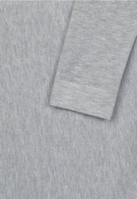 Light gray cotton sweater featuring a smooth texture, round neckline, and long sleeves with knit cuffs.