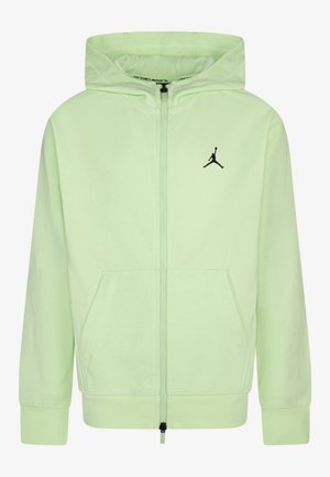 Sweat à capuche zippé vert clair avec poches avant, une capuche et un petit logo Jumpman noir sur la poitrine gauche.