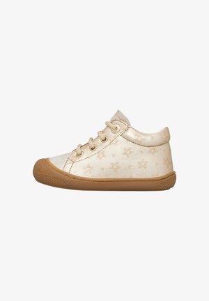 Gold faux leather sneaker with star pattern, round toe, lace-up design, tan rubber sole, low top silhouette.